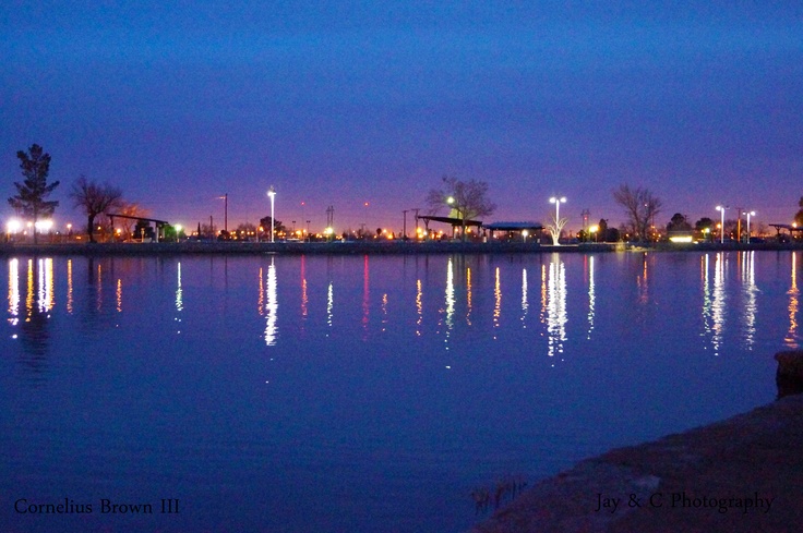 a body of water at night with buildings in the background