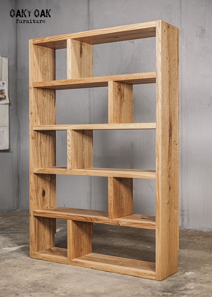 a wooden book shelf sitting on top of a cement floor