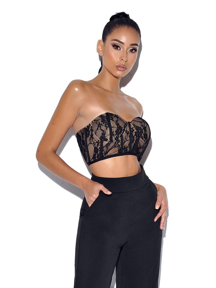 Keep it chic in this black lace corset crop top! This fully lined strapless stretch lace top is perfect for adding a touch of glam to any look. The nude lining and zippered back add subtle detailing. Pair with our easy to wear Never Enough Wide Leg Trouser for a flattering weekend look! (sold separately). Available in black and white. Materials: Lace / Stretch Mesh / Boned Corset Length: Approx 6 inch / 15 cm Stretch Factor: Low Stretch Clean: Dry-clean only Model Is Wearing A Size XS (US-2) Mod Black Lace Corset Top, Stretch Lace Top, Black Lace Crop Top, Crepe Pants, Black Lace Corset, Lace Corset Top, Tie Dye Jumpsuit, Corset Crop Top, New Romantics