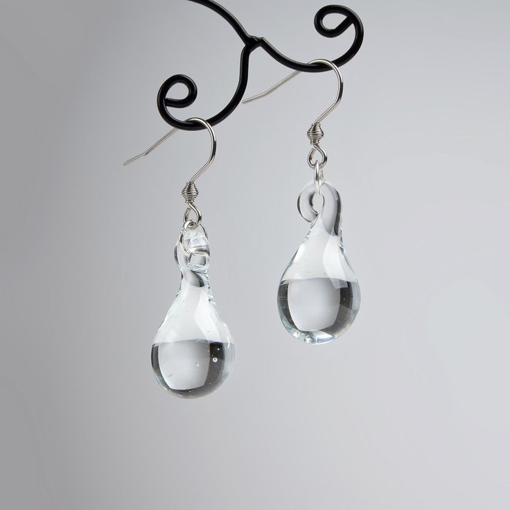 "These Clear teardrop earrings are made of glass in lampwork technique. The stainless steel hooks are hypoallergenic. They will not tarnish, fade, or discolor with time. These unique and beautiful earrings are like water drops frozen in glass! They are simple and elegant, very lightweight and comfortable to wear, perfect for everyday wear and for special occasions. You will definitely receive lots of compliments on your new earrings, everybody loves them, and you'll love them too! Dimensions: to Minimalist Teardrop Glass Jewelry, Modern Glass Teardrop Earrings, Glass Drop Earrings With Matching Set, Hypoallergenic Glass Teardrop Jewelry, Glass Drop Earrings As Gift, Nickel-free Teardrop Glass Earrings, Glass Teardrop Earrings With Ear Wire, Teardrop Glass Earrings With Ear Wire, Clear Teardrop Jewelry With Matching Earrings