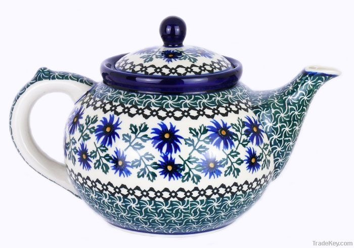 a blue and white teapot with flowers on it