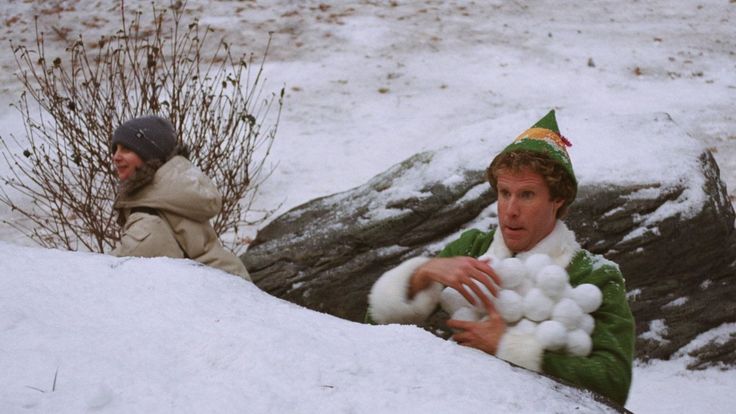 two people in the snow with hats on