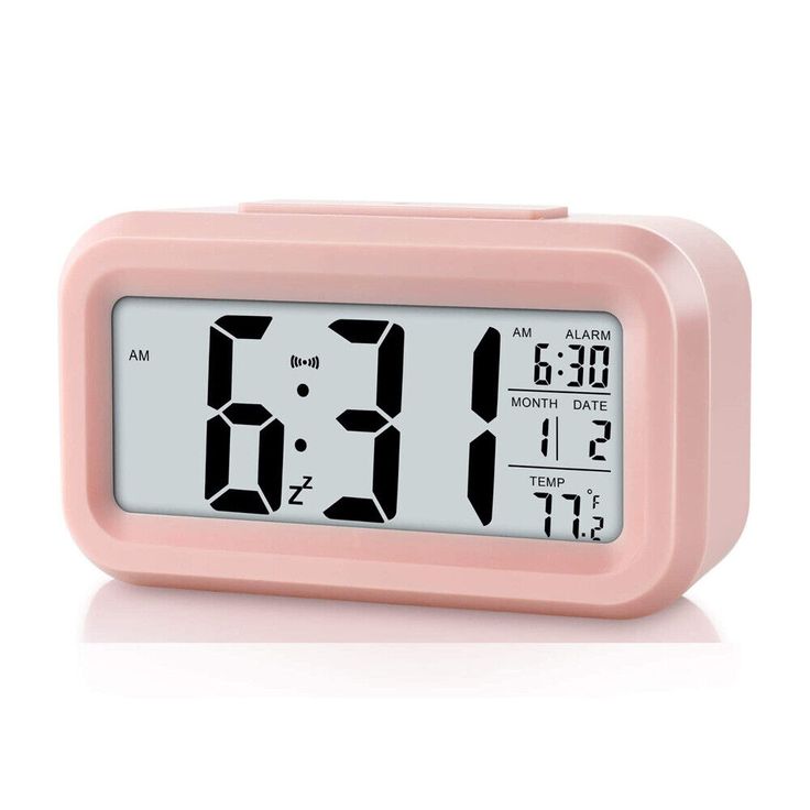 a pink alarm clock with the time at 11 00 pm on it's display