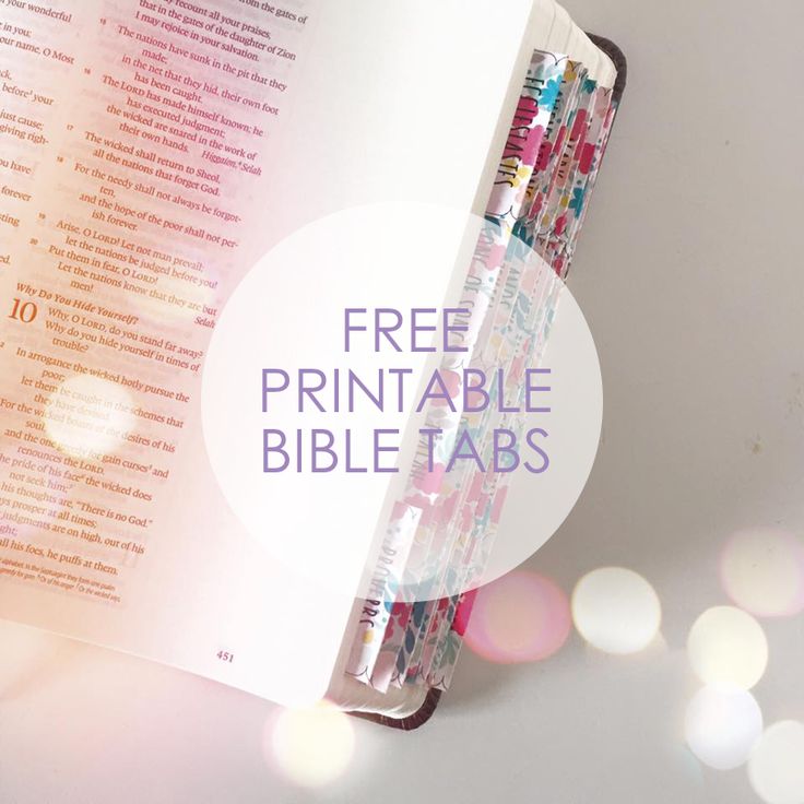 an open bible with the words free printable bible tabs on it, in front of bright boke