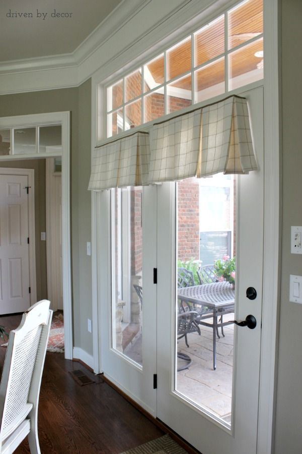 a dining room table and chairs are in front of the sliding glass doors