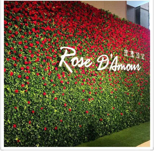 the rose - d'avon sign is covered in red flowers and greenery