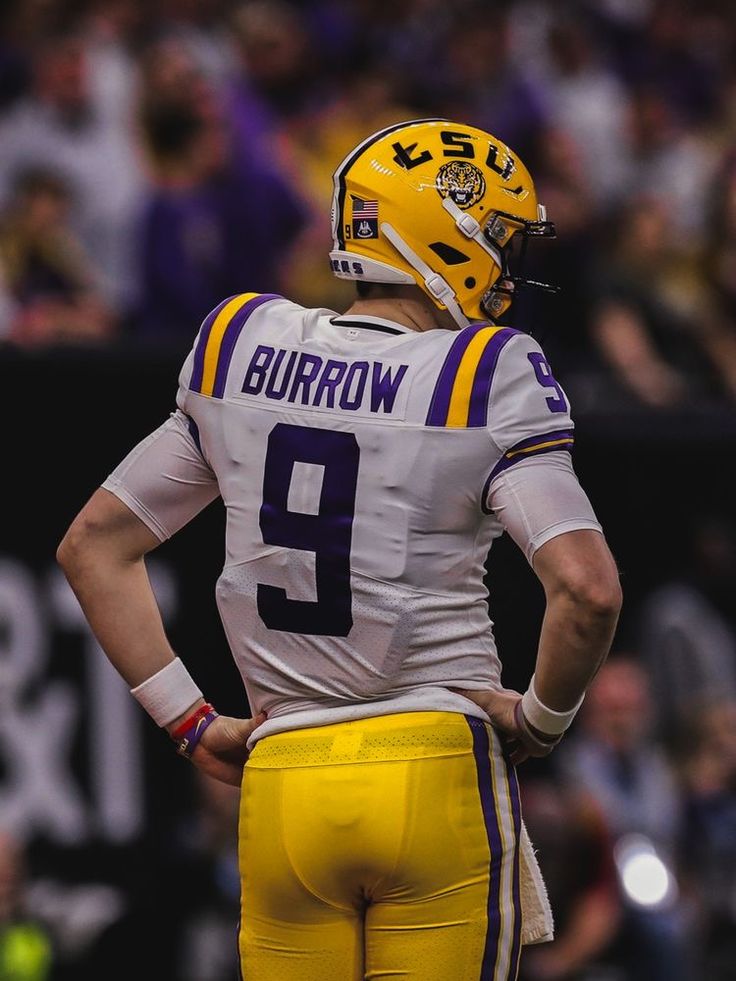 a football player with his back turned to the side wearing a yellow and white uniform