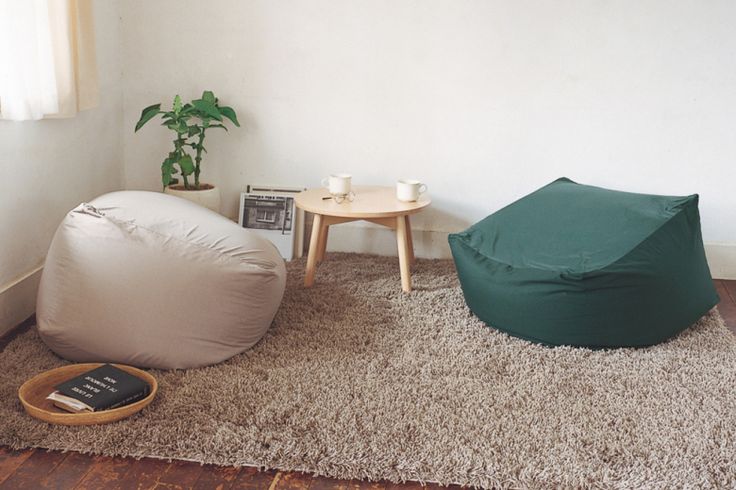 a living room with a bean bag chair and coffee table