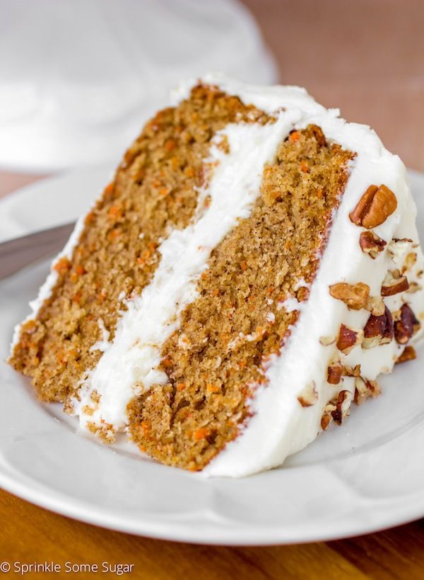 a slice of carrot cake on a white plate