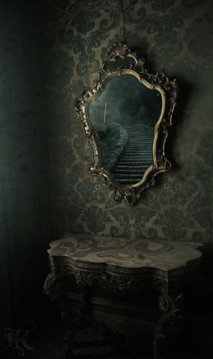 a mirror sitting on top of a table next to a wall