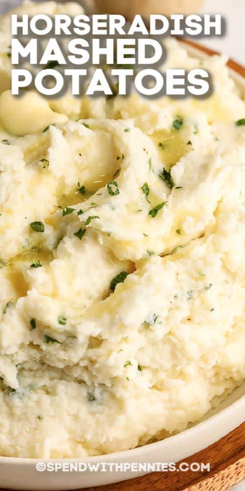 mashed potatoes in a white bowl with herbs on top and text overlay that reads, horseradish mashed potatoes