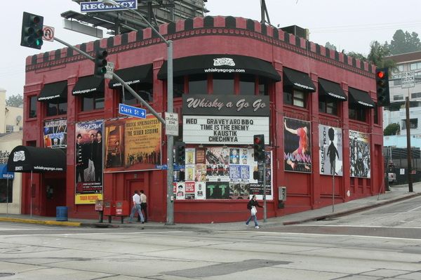 a red building on the corner of a city street