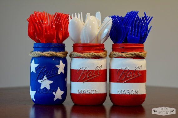 four patriotic mason jars with toothbrushes in them