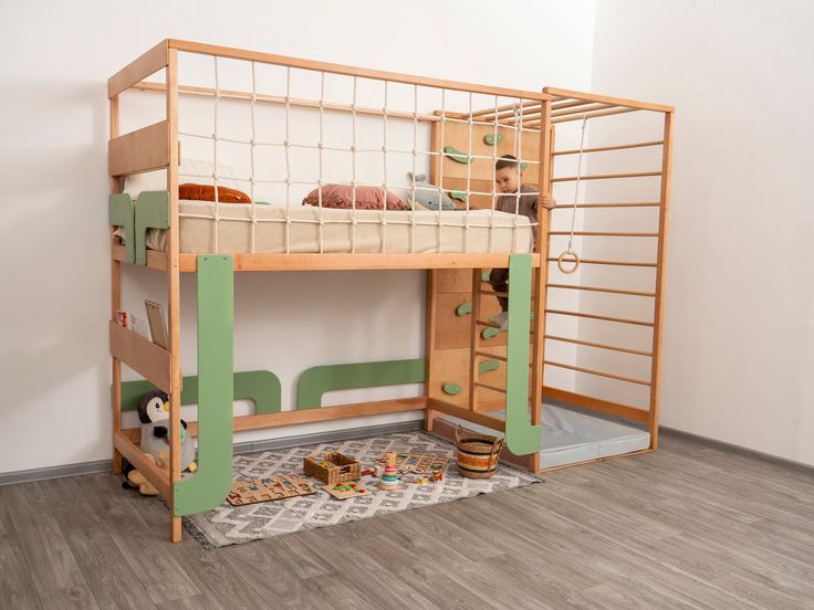 a wooden bunk bed sitting on top of a hard wood floor next to a white wall