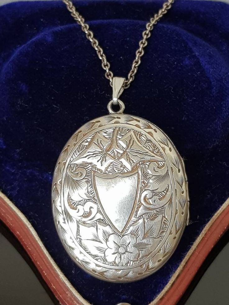 "Gorgeous sterling silver Antique Victorian Aesthetic (circa 1880's, no hallmarks, common in this era, however tested as silver)  ornately engraved double sided locket finely detailed with vacant cartouche in the shape of a shield surrounded by flowers and ivy leaves with decorative border.  To the other side, is a \"greek key meander\" design signifying \"eternity\" again surrounded by decorative ivy leaves and scrolls.  A beautiful piece that looks like it was originally gilded (gold on silver) as it has very slight traces of this which is seen in the photos and can also be worn either way be worn either way around as a new (more modern sterling silver clip loop bail)  allows the owner to choose to change it around to which is side preferred. Opens at the side and closes well to reveal t Antique Silver Sterling Silver Vintage Locket Necklace, Victorian Antique Silver Necklace With Intricate Design, Antique Silver Locket Necklace For Formal Occasions, Vintage Sterling Silver Engraved Locket Necklace, Vintage Engraved Sterling Silver Locket Necklace, Formal Antique Silver Locket Necklace, Vintage Engraved White Gold Necklace, Victorian Silver Locket Necklace, Silver Hallmarked Locket Necklace Collectible