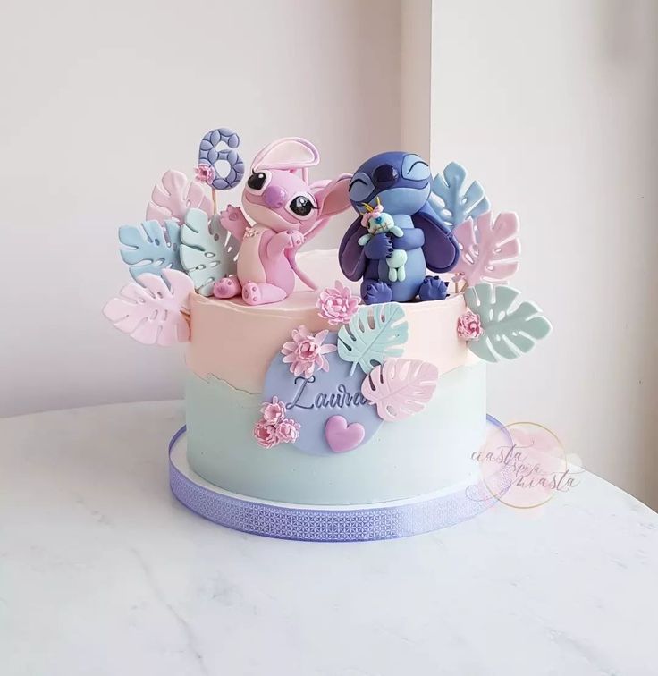 there is a cake decorated with little ponys and flowers on the top of it