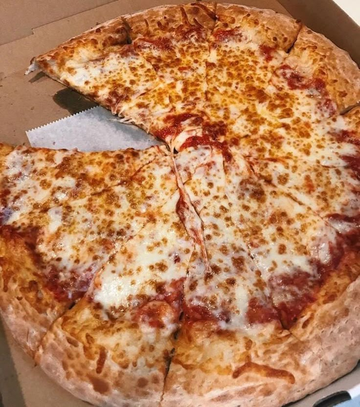 a pizza in a box with one slice missing