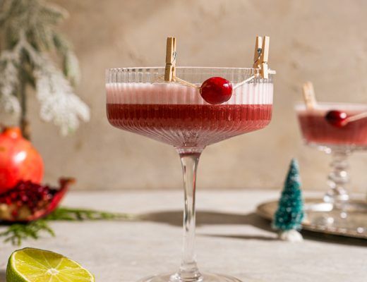 two glasses filled with drinks sitting on top of a table