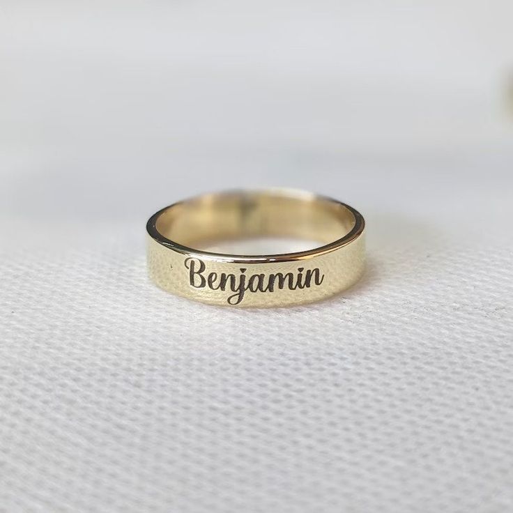 About item Item :- Custom Band engraved ring Ring size :- Chose from variation (Custom size accepted) Material  :- 925 Sterling silver Purity  :- 92.5 Title:- Personalized Word Ring, Custom Name Ring, Dainty Name Ring, Personalized Stacking Ring Gift, Unisex Ring, Unique Anniversary Gift for Her, Valentine's day gift, Promise ring, Couple rings, Girlfriend ring, Delicate ring Description:- We use 925 sterling silver to making jewelry. We accept all types of custom & personalized order. Please send us a message if you are interested in a custom creation. Shipping profile:- We ship all order within 3-5 days. But custom order takes time. Customer service :- If you have any question about our products & services, feel free to contact us. We do always best for our customers Other Specification: Initial Ring Gold Personalized, Gold Jewelry With Engraved Text For Promise, Adjustable Engraved Ring With Round Band, Adjustable Engraved Promise Ring, Adjustable Stamped Engraved Ring With Round Band, Promise Jewelry With Engraved Text In Round Shape, Promise Jewelry With Engraved Text, Round Ring With Engraved Text For Anniversary, Adjustable Engraved Initial Ring For Wedding