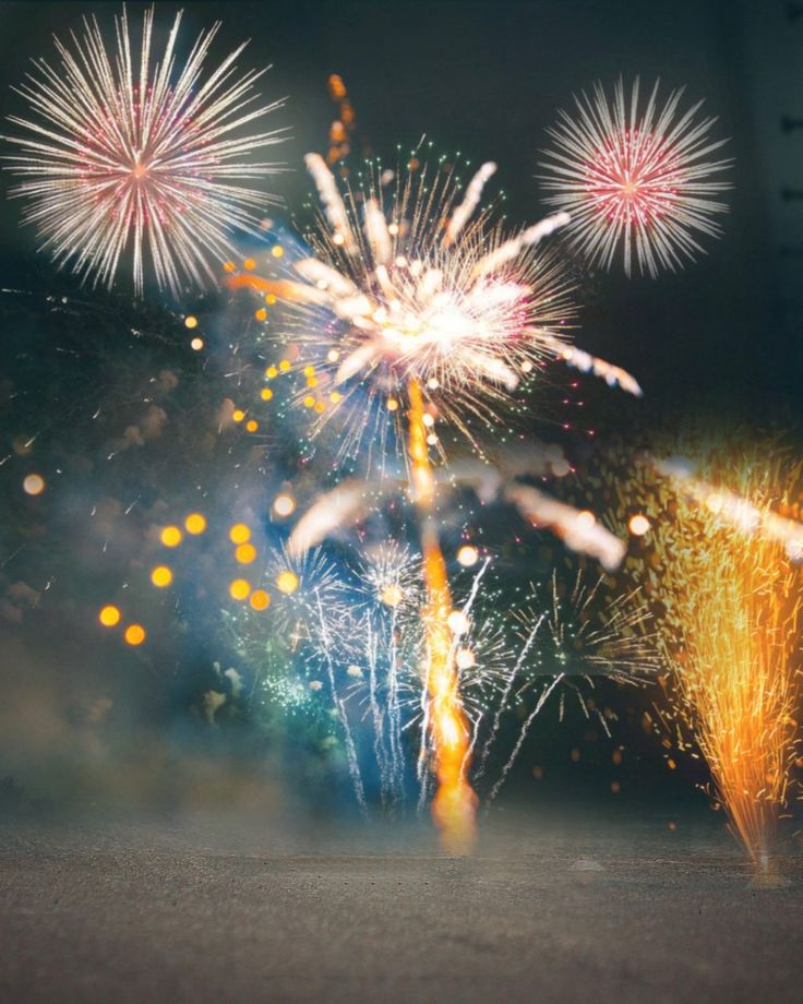 fireworks are lit up in the night sky with bright colors and sparkles on them