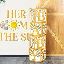 there is a sign that says here is mom in the sun next to a vase with flowers