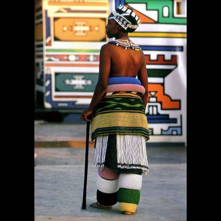 a person with a stick standing in front of a bus