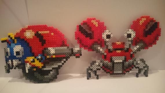 three lego sculptures made to look like cars and motorcycles are shown in front of a white wall