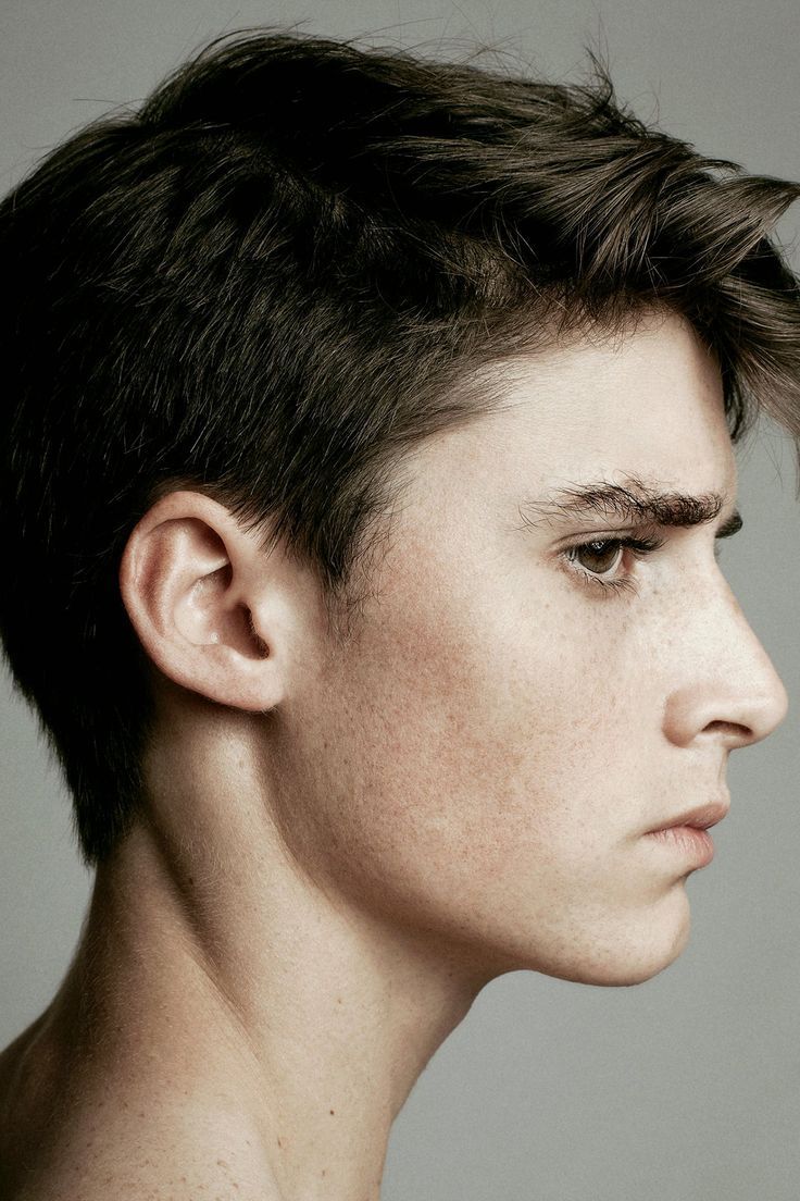 a close up of a person with a short haircut and freckled undercut