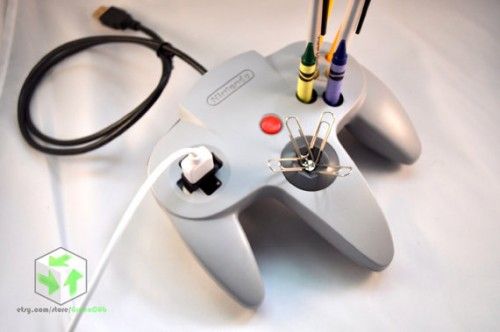 a video game controller sitting on top of a white table next to a black cord