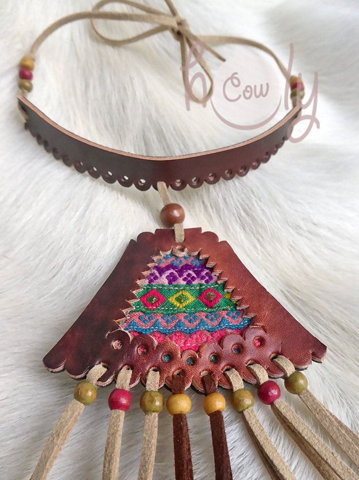 Unleash your bohemian soul with this beautiful one off unique handmade leather necklace. It is made from the finest quality brown leather. The brown leather section of the necklace has vintage hand embroidered Hmong tribal fabric incorporated into it's design. This is not only a necklace it is a piece of art. This long fringe leather choker necklace is adjustable at the back so it fits all sizes. Available in a wide range of colors. Please contact me if you would prefer a different color combina Hand-stitched Adjustable Bohemian Jewelry, Brown Hippie Jewelry For Festivals, Hippie Brown Jewelry For Festivals, Handmade Brown Hippie Necklaces, Handmade Brown Hippie Necklace, Artisan Embroidered Necklaces For Festivals, Artisan Hand-stitched Festival Jewelry, Traditional Leather Jewelry For Festival, Handmade Vintage Brown Leather Jewelry