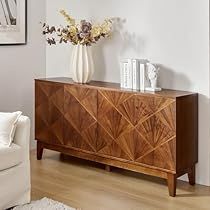 a living room scene with focus on the sideboard and vase filled with flowers in it