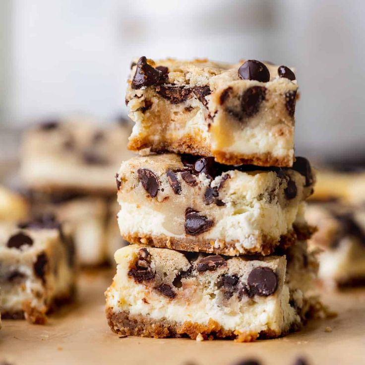 chocolate chip cheesecake bars stacked on top of each other