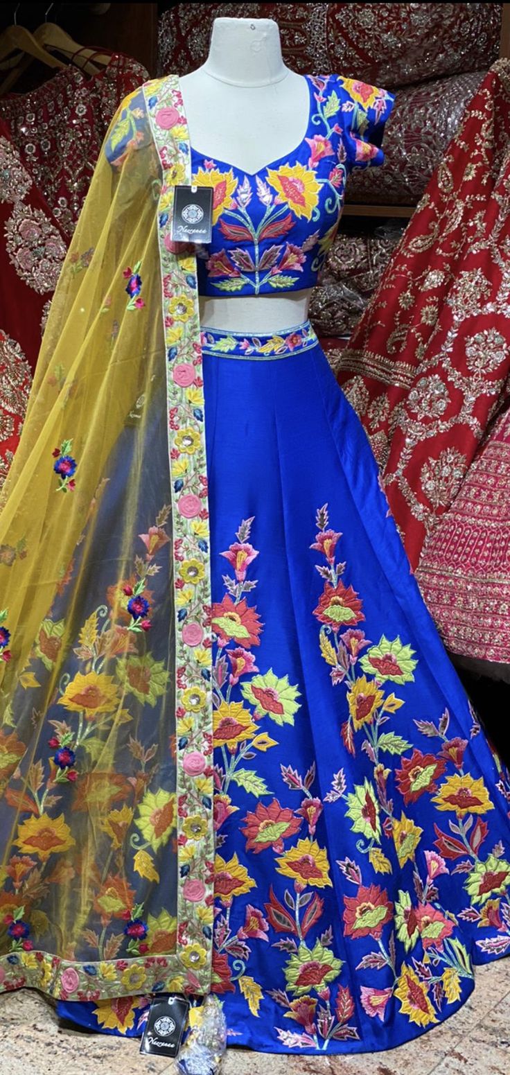 Royal blue summer blossom pattern with colorful flowers hand embroidered patchwork design lehenga. Available with matching embroidered blouse and contrasting light yellow embroidered net dupatta. All you need to slay that perfect look and this is how! Fabric : Silk Size: 38 Ready to Ship! Festive Floor-length Choli With Floral Embroidery, Festive Floor-length Floral Embroidered Choli, Navratri Floor-length Sets With Floral Embroidery, Floral Embroidered Sharara For Designer Wear And Diwali, Navratri Anarkali Sharara With Floral Embroidery, Bollywood Anarkali Set With Floral Embroidery For Navratri, Floor-length Floral Embroidery Choli For Festive Occasions, Floor-length Floral Embroidery Set For Festivals, Festive Floor-length Floral Embroidery Choli