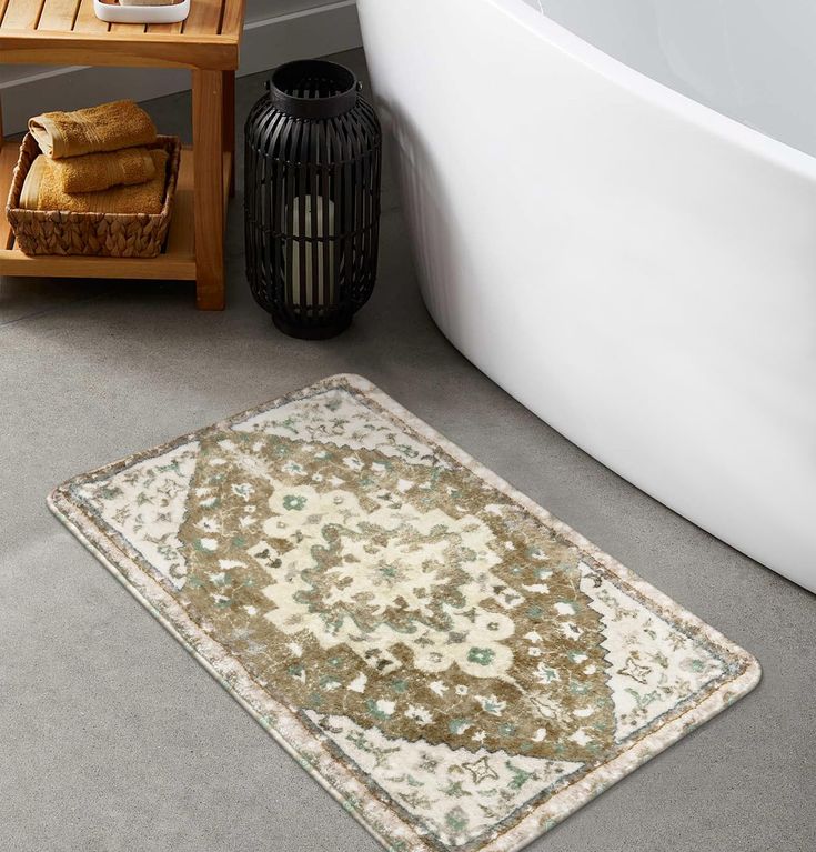 a bath tub sitting next to a rug on the floor