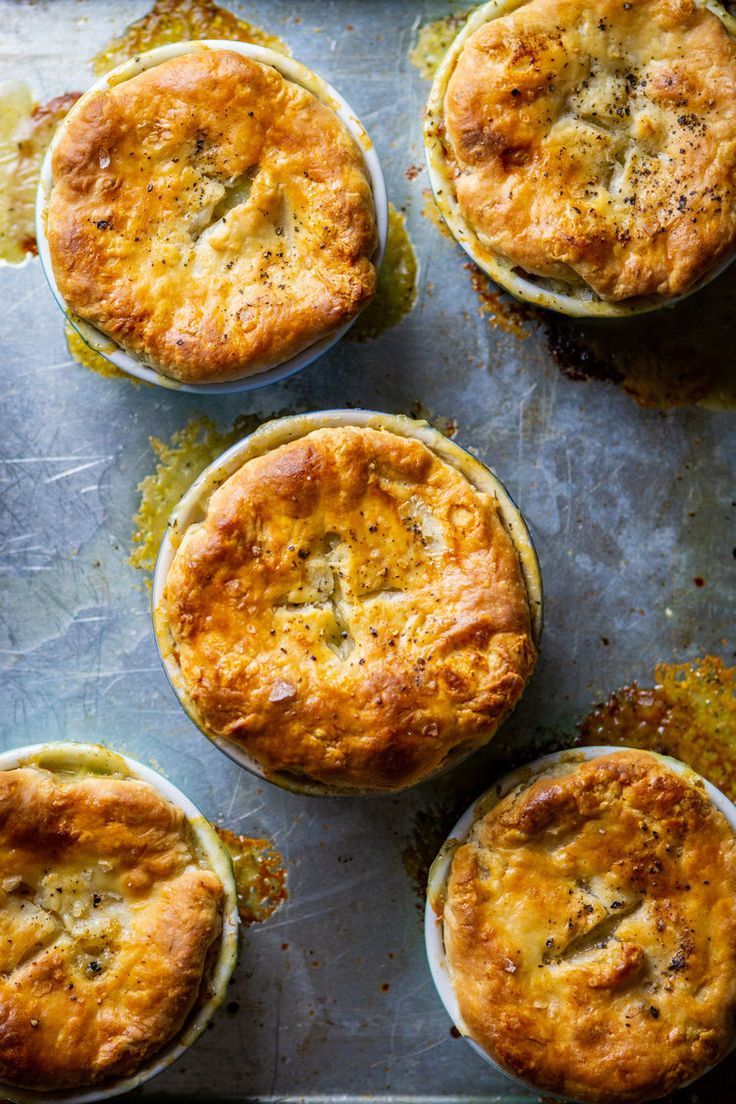 four baked pies sitting on top of a baking sheet