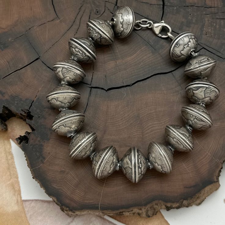 Embrace The Exquisite Craftsmanship Of This Bracelet, Meticulously Designed And Handcrafted By The Skilled Native American Artisans Of Buffalo Dancer From Taos Pueblo, New Mexico. Featuring 15 Mesmerizing 16mm Beads, Each Meticulously Formed By Doming And Joining A Pair Of Vintage Mercury Dimes, This Bracelet Exudes Timeless Allure. Secured With A Lobster Claw Clasp And Ring Closure, The Beads Are Strung On Foxtail Wire, Ensuring Both Durability And Security. Crafted From Coin Silver And Sterlin Adjustable Polished Beads Bracelets For Festivals, Artisan Silver Beaded Bracelets, Artisan Bracelets With Polished Beads, Traditional Silver Beaded Bracelets With Spacer Beads, Silver Beaded Bracelets With Round Beads For Festivals, Bohemian Silver Beaded Bracelets With Large Beads, Polished Beads Bracelet For Wedding, Artisan Silver Bracelets With Round Beads, Artisan Silver Bracelet With Round Beads