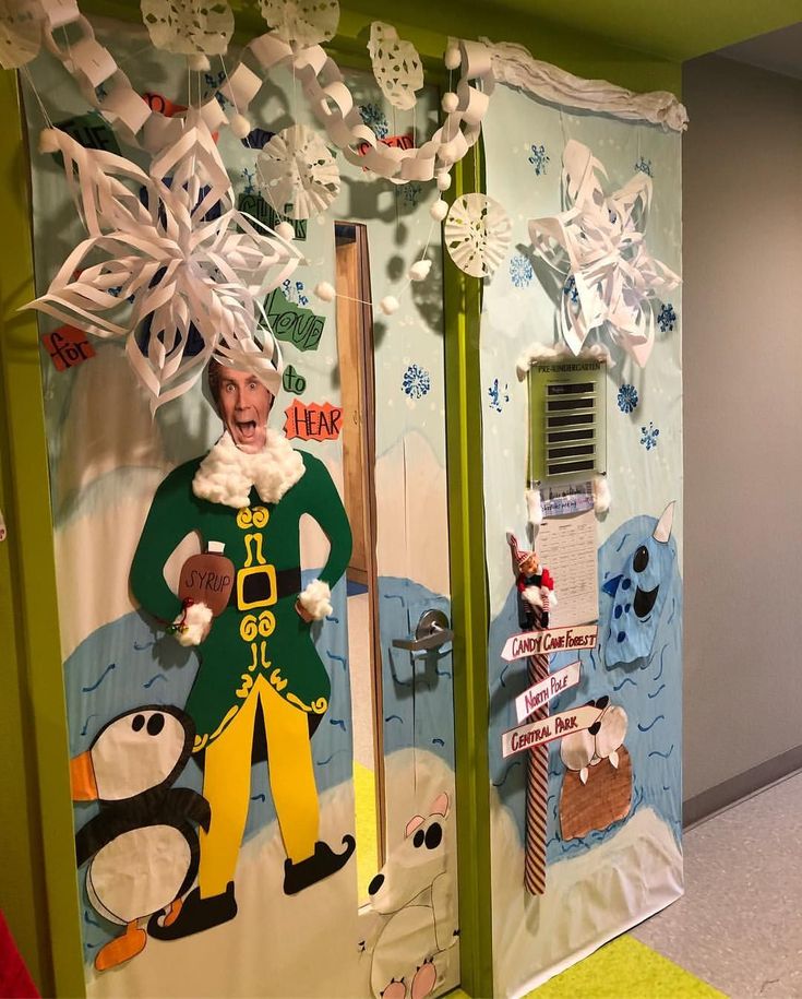 an office decorated with paper mache characters and snowflakes on the doors to their cubicles