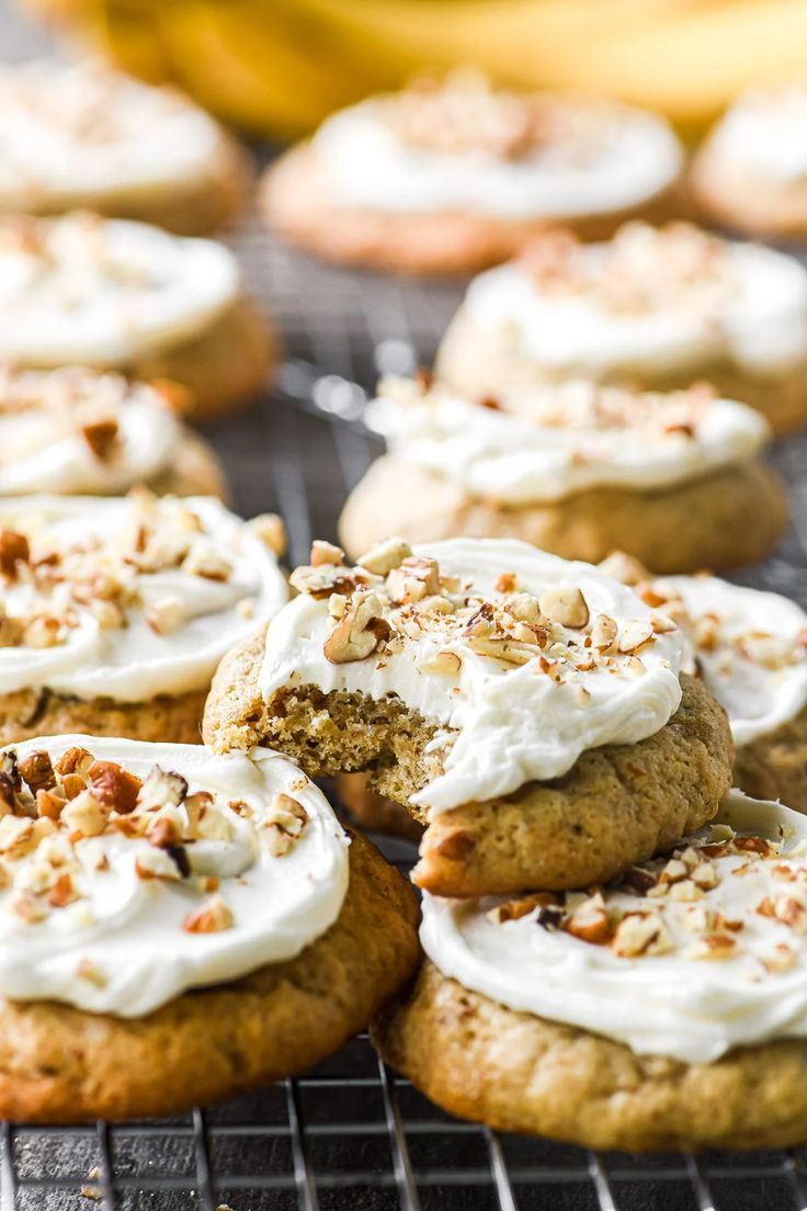 cookies with white frosting and nuts on a cooling rack