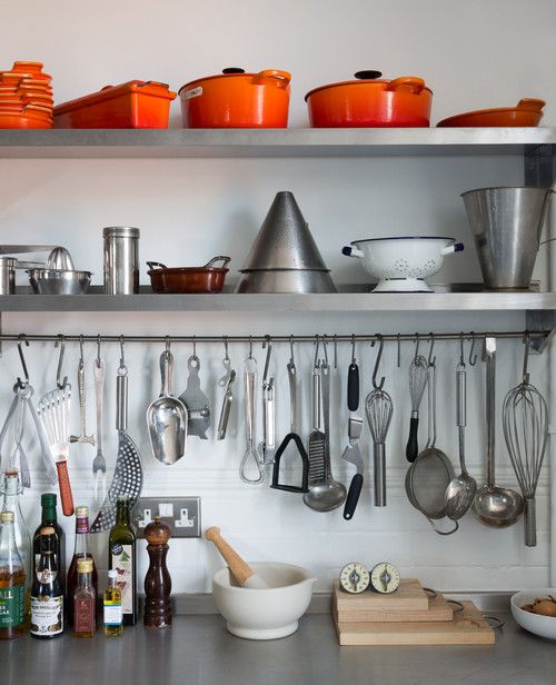 the shelves are full of cooking utensils and other kitchen items, including pots and pans