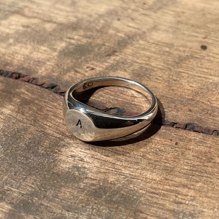 Make it personal... A classic small circle signet ring hand-stamped with your desired initial. Simply enter the letter of your choice in the order notes. These timeless signet rings are meticulously crafted by hand in our Melbourne workshop, created out of wax and then cast into precious metal. Made with the highest quality Australian sterling silver to last forever. Made solid, not hollow like many others, all of our rings are hand-stamped with a Sterling Silver (925) hallmark and Custom Creed Classic Adjustable Initial Ring For Everyday, Heirloom Style Personalized Everyday Rings, Minimalist Initial Ring With Engraving Option, Personalized Timeless Rings For Everyday, Minimalist Engraved Ring For Everyday Wear, Adjustable Initial Ring For Everyday, Timeless Personalized Rings, Timeless Everyday Personalized Rings, Everyday Personalized Timeless Rings