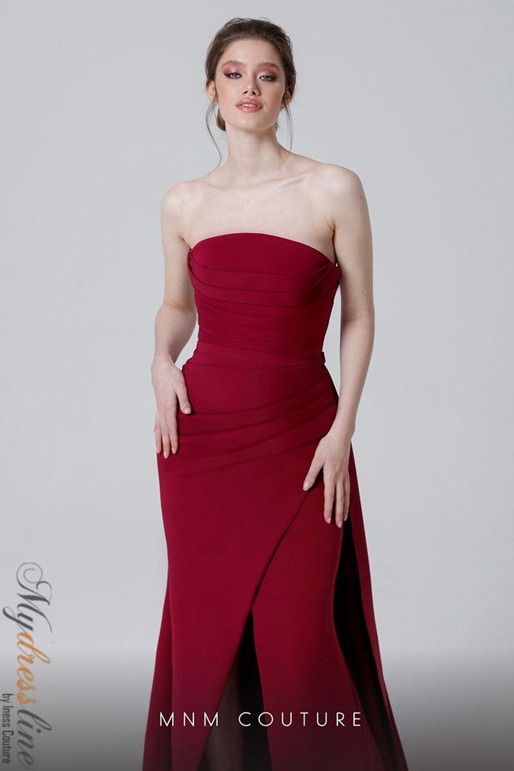 a woman in a long red dress posing for a photo with her hands on her hips