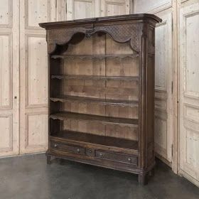 an old wooden bookcase sitting in front of a wall