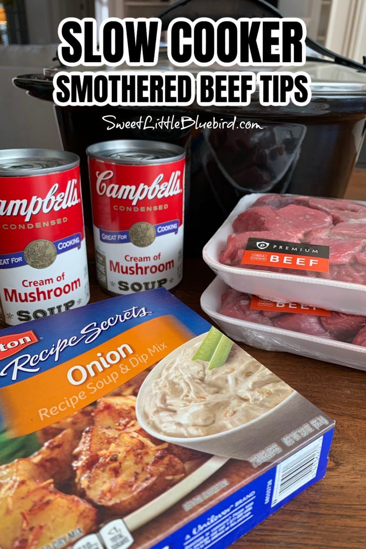 Photo of the ingredients to make Slow Cooker Smothered Beef Tips with Mushroom and Onion Gravy - Photo of Black Slow Cooker in the background with 2 cans of Campbell's Cream of Mushroom soup, box of Lipton Onion Soup Mix and 2 packages of Stew Beef. Slow Cooker Smothered Beef Tips, Beef Tips And Gravy Crockpot French Onion Soup, Smothered Beef Tips Crock Pot, Slow Cooker Beef In Onion Gravy, Beef Tips And Egg Noodles Crockpot, Crockpot Stew Meat And Potatoes, Slow Cooker Beef Tips With Mushrooms, Crock Pot Beef Stroganoff With Stew Meat, Easy Beef Tips And Gravy Crock Pots