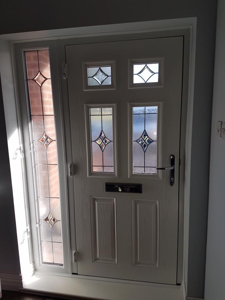 a white door with stained glass on it