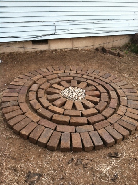 a fire pit made out of bricks on the ground