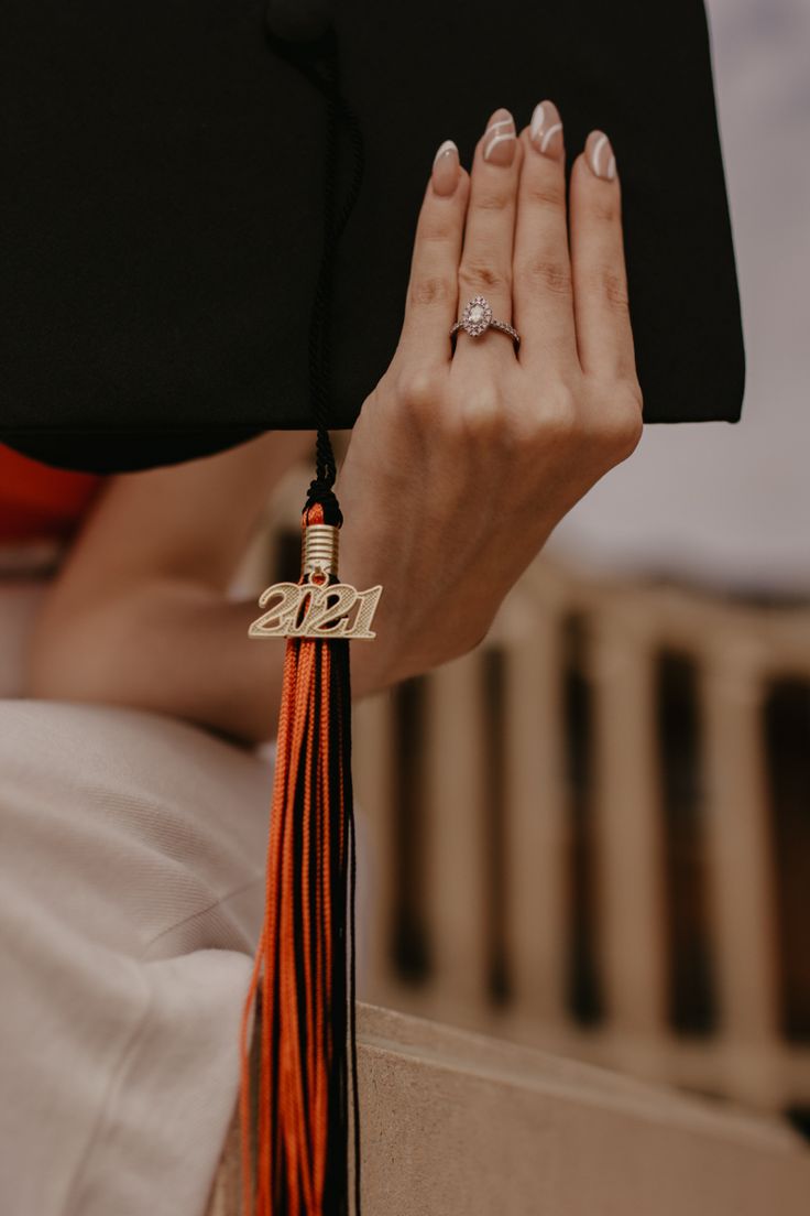 a close up of a person's hand with a tassel on her wrist