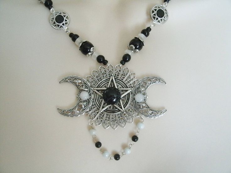 "This beautiful necklace has a black obsidian stone, moonstone settings, pewter silver pentacle, sterling silver plated triple moon pendant, moonstone beads, black obsidian beads, seed beads, pewter silver bead caps, pewter silver filigree connectors and metal chain. 18\" long. Sterling silver plated toggle clasp." Gothic Jewelry With Moon Charm, Black Moon Phase Necklaces For Festival, Black Moon Phase Necklace For Festival, Gothic Festival Jewelry With Moon Charm, Gothic Nickel-free Necklaces For Festivals, Gothic Adjustable Necklace With Moon Charm, Black Moon Charm Jewelry For Festivals, Gothic Silver Wire Wrapped Jewelry, Black Moon Phase Jewelry For Festivals