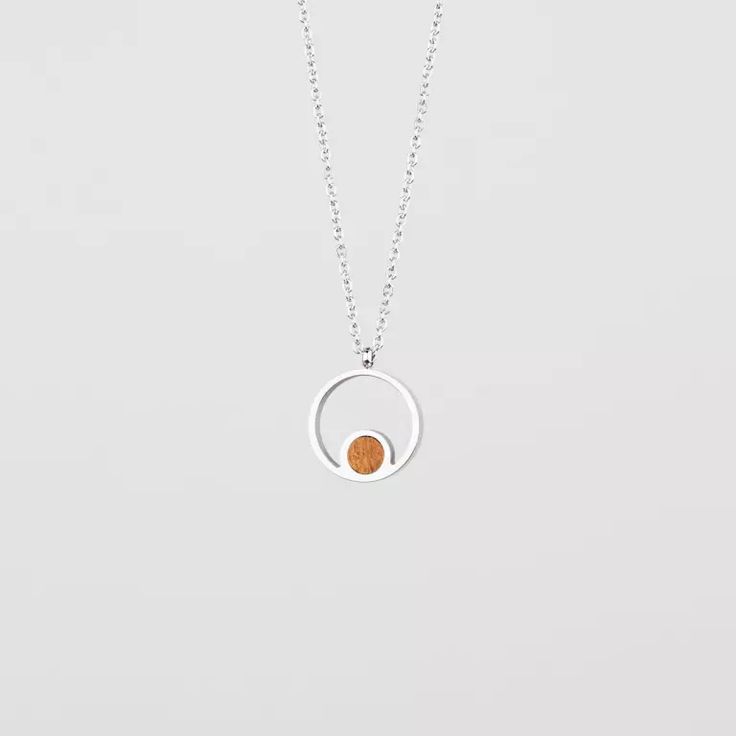 Pigment Necklace (Koa/Silver) | Holzkern Dainty Round Jewelry With Adjustable Length, Adjustable Circle Necklaces For Everyday, Everyday Adjustable Circular Necklaces, Adjustable Sterling Silver Round Charm Necklace, Adjustable Round Sterling Silver Charm Necklaces, Minimalist Sterling Silver Amber Jewelry, Minimalist Amber Sterling Silver Jewelry, Nickel-free White Gold Circular Jewelry, Modern Pendant Jewelry With Clavicle Chain