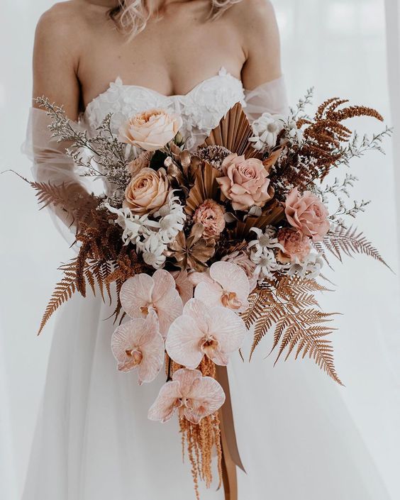 a woman holding a bouquet of flowers on her wedding day with the caption madewithlovebridl