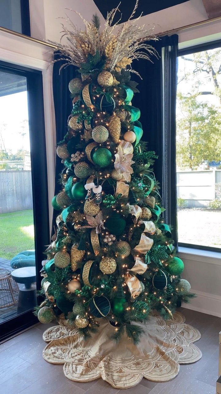 a decorated christmas tree with green and gold ornaments